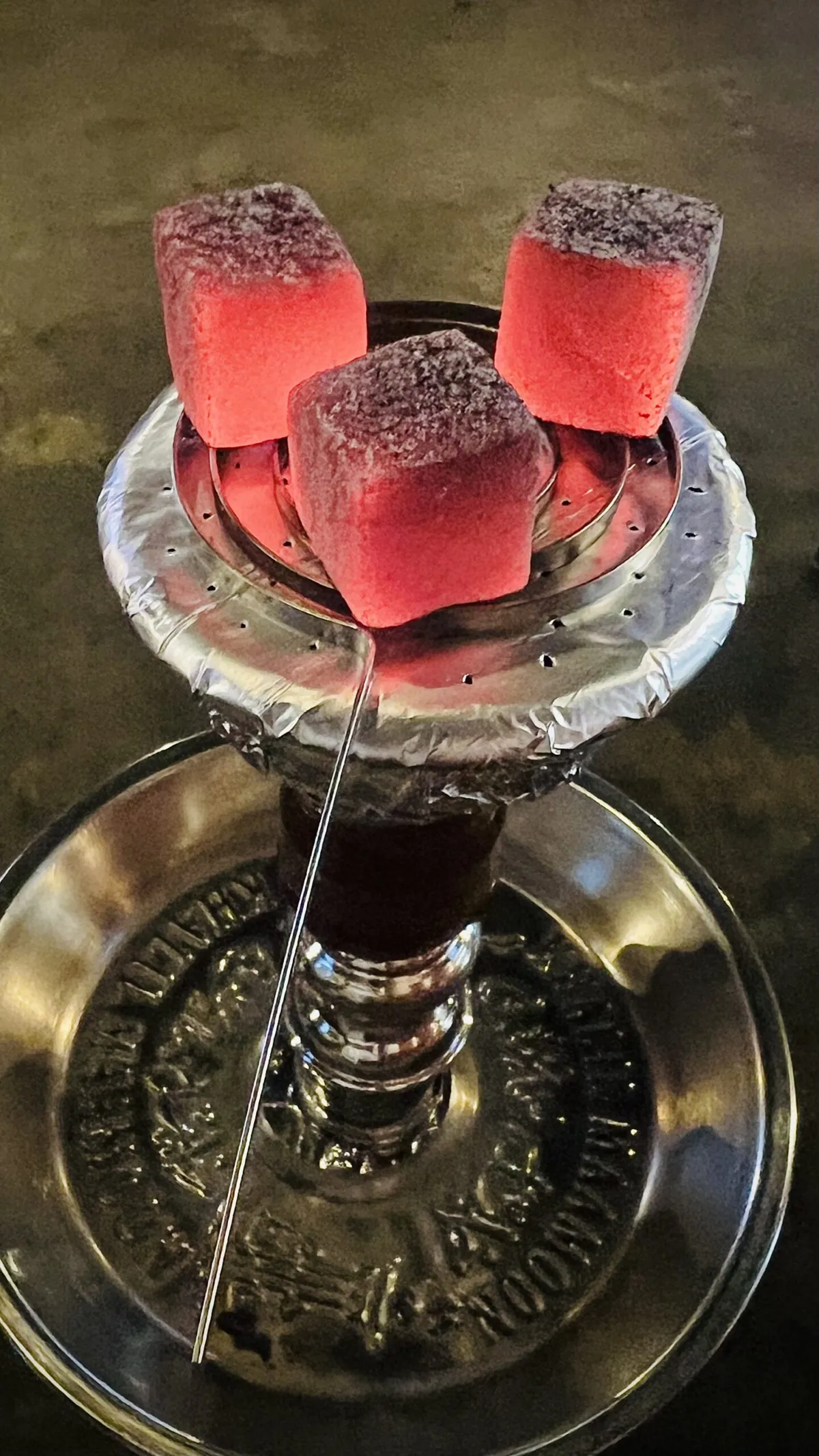 Glowing coals on a hookah bowl